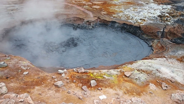 Eruption of Geyser in Iceland. Red Soil, Like the Surface of the Planet Mars alt