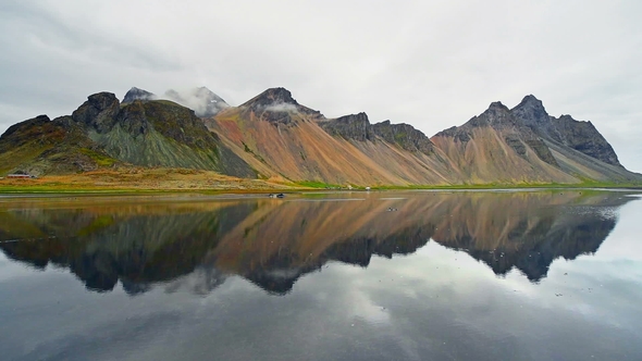 Amazing Mountains Reflected in the Water at Sunset. Stoksnes, Iceland