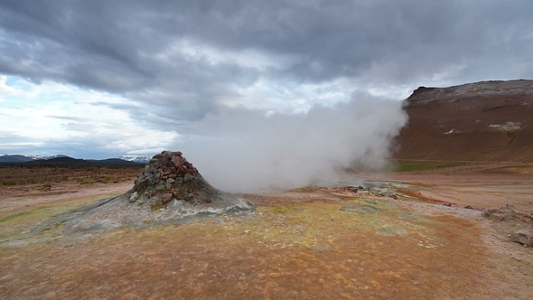 Eruption of Geyser in Iceland. Red Soil, Like the Surface of the Planet Mars alt
