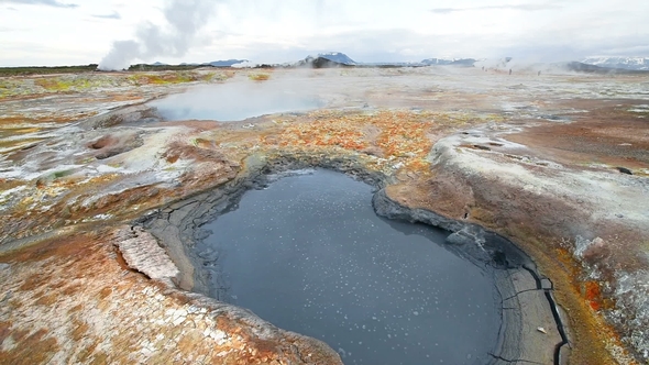 Eruption of Geyser in Iceland. Red Soil, Like the Surface of the Planet Mars alt