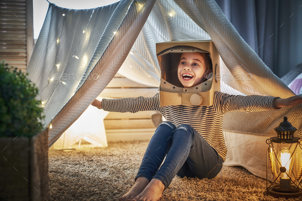 kid playing in tent - Stock Photo - Images