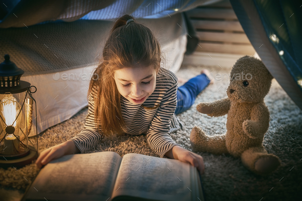 child is reading a book - Stock Photo - Images