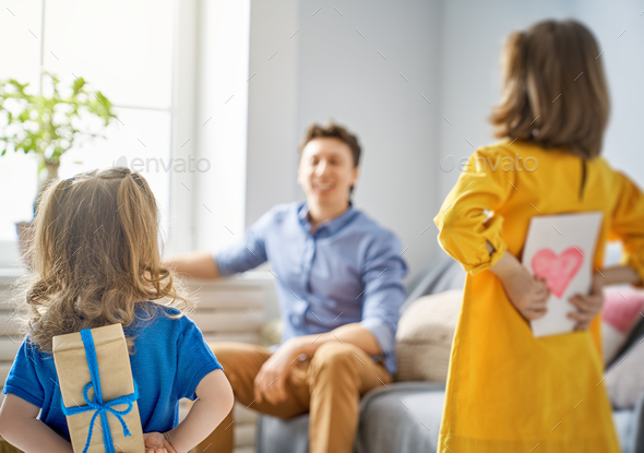daughters congratulating dad - Stock Photo - Images