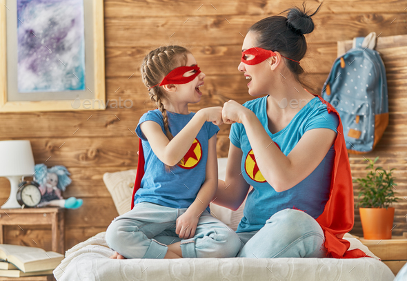 Girl and mom in Superhero costume - Stock Photo - Images