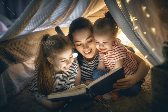 Mom and children reading book - Stock Photo - Images