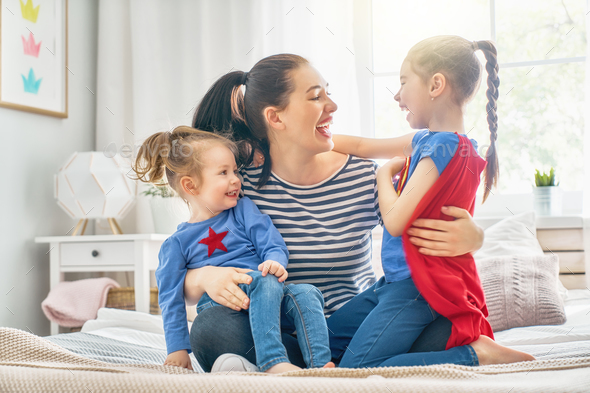 Mom and her daughters are playing - Stock Photo - Images
