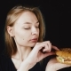 Bad Hamburger. Poor Food. The Girl Looks at the Hamburger in Disgust. Bad Fast Food - VideoHive Item for Sale