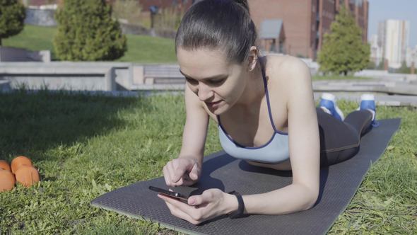 Woman Using Smartphone to Find new Fitness Exercises