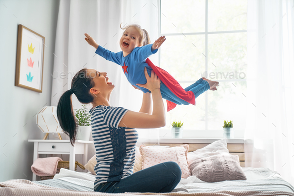 Girl and mom in Superhero costume - Stock Photo - Images