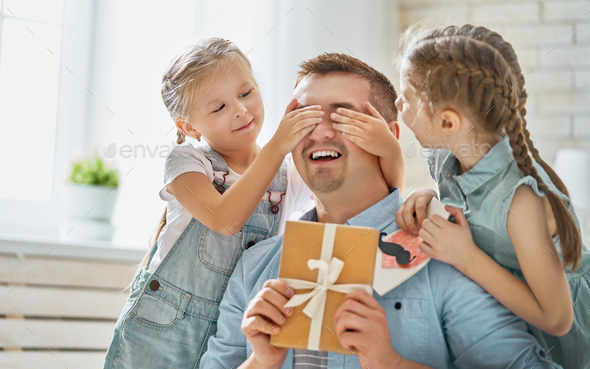 daughters congratulating dad - Stock Photo - Images
