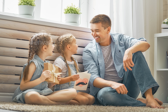 daughters congratulating dad - Stock Photo - Images