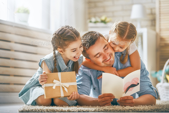 daughters congratulating dad - Stock Photo - Images