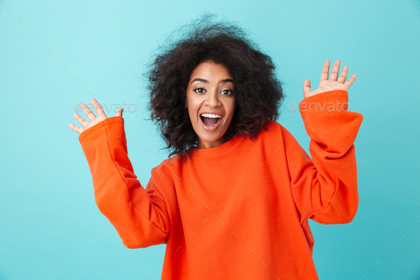 Colorful portrait of happy woman in red shirt looking on camera - Stock Photo - Images