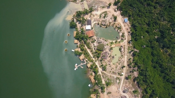Drone View Boat Pier and Bungalow for Rest on Lake Among Tropical Nature in Mountains. Green Water