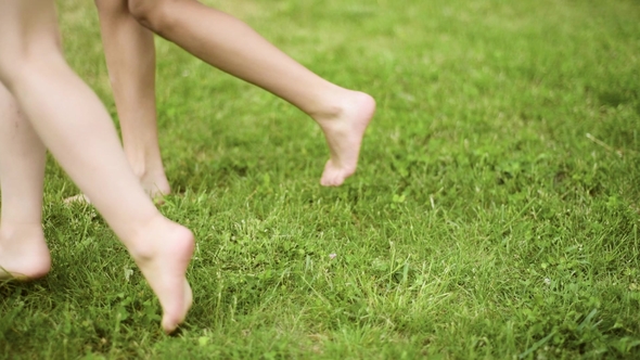 Children Feet on Green Grass