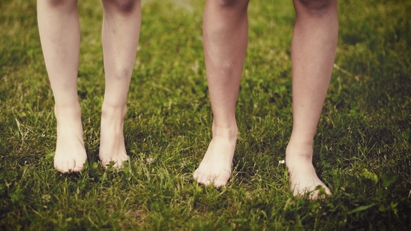 Children Feet on Green Grass