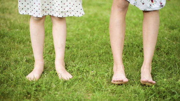 Children Feet on Green Grass