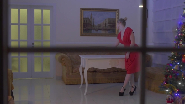 Young Woman in Red Sexy Dress Drink Wine and Dance Celebrating Christmas Alone alt