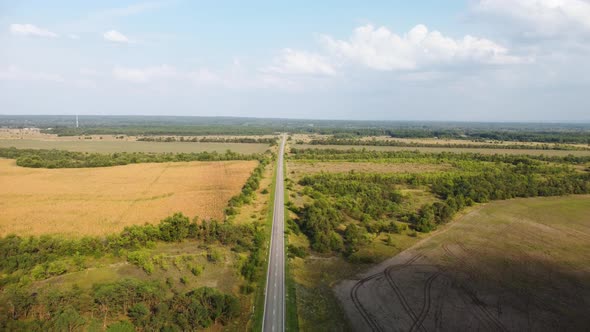a Highway Stretching to the Horizon Among Agricultural Fields