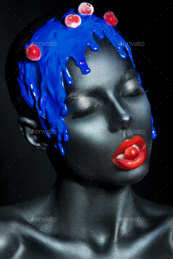 fashion portrait of a dark-skinned girl with color make-up. Beauty face. Stock Photo by korabkova