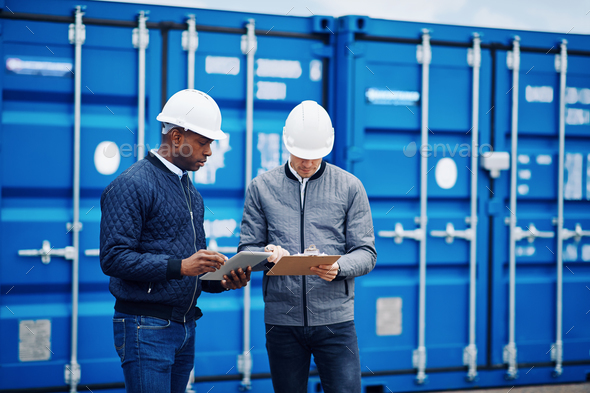 Two engineers tracking containers in a freight yard - Stock Photo - Images
