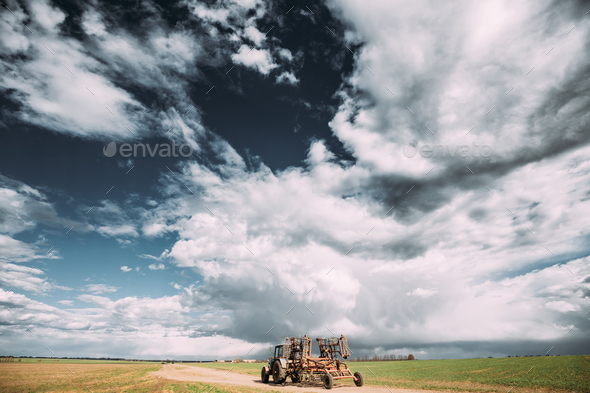 Tractor With Attached Harrow In Sunny Spring Day. Countryside Ru - Stock Photo - Images