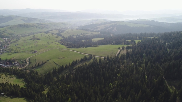Flight Over the Forest in the Mountains and Village  View of Ukrainian Carpathians