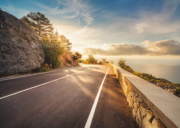 Mountain asphalt road at sunset in summer in Europe - Stock Photo - Images
