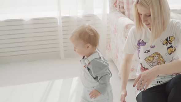 Little Lovely Baby Take Her Bottle and Drink. Happy Family.