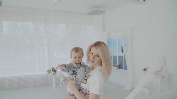 Mother Swinging Her Beautiful Daughter in the Room