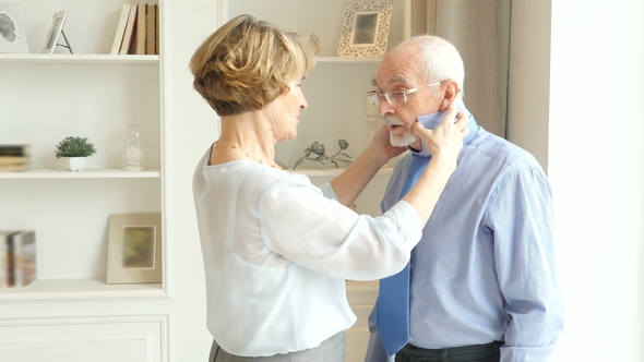 Happy Older Couple, Older Wife Helps To Put On a Tie For Her Elderly Husband