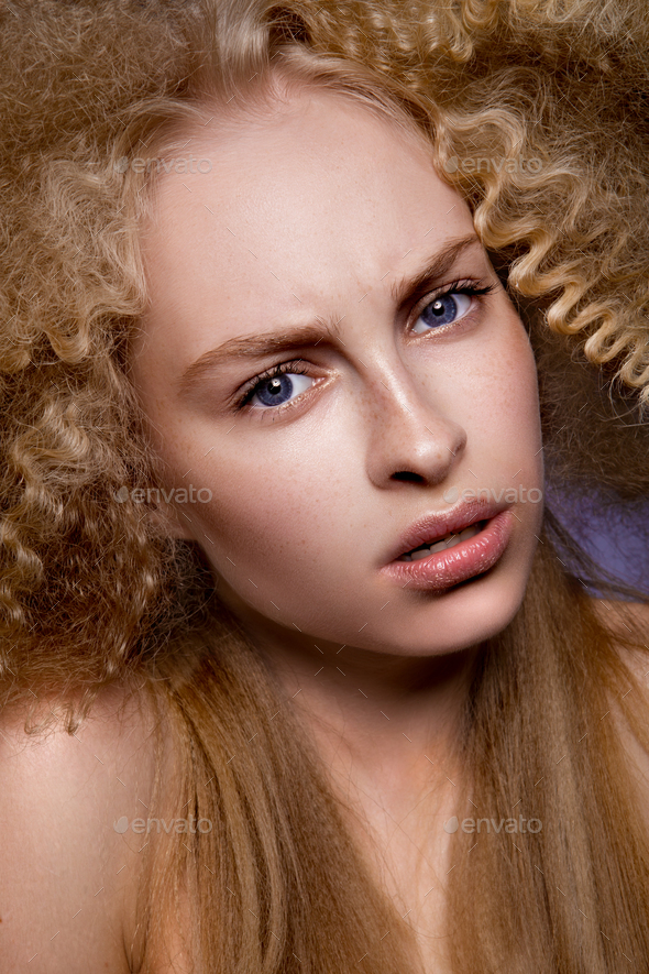 Beautiful blonde model girl with long curly hair . - Stock Photo - Images