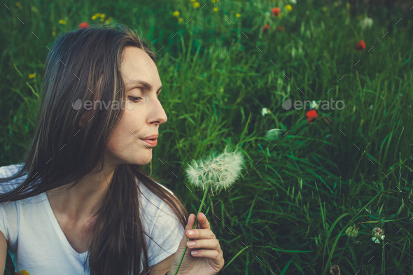 Allergy free concept. Woman blowing dandelion - Stock Photo - Images