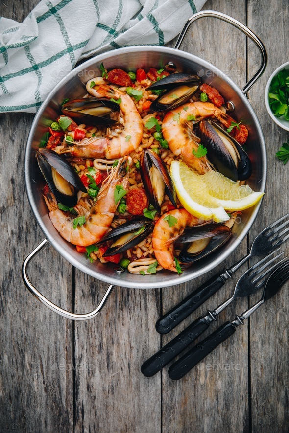 Spanish seafood paella with mussels, shrimps and chorizo sausages in