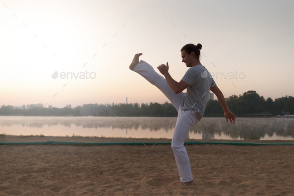 Capoeira on the beach, near lake in the park one performer, at s - Stock Photo - Images