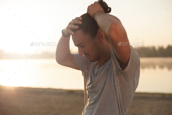 Handsome man resting after workout in the park - Stock Photo - Images