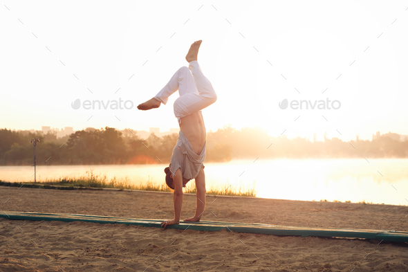 Athletic young man workout mornings in the park near lake - Stock Photo - Images