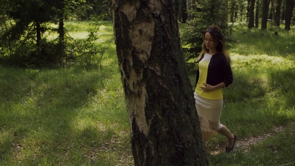 A Girl Walks through the Forest
