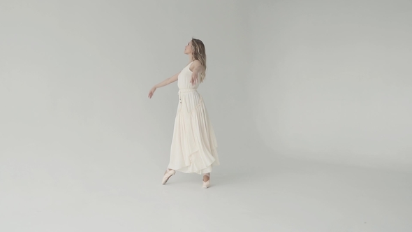 Ballerina in White Waving Dress and Pointes Beautifully alt