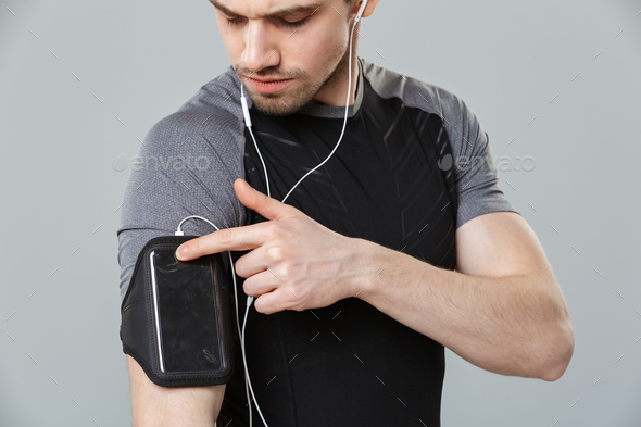 Cropped image of a concentrated young sportsman - Stock Photo - Images