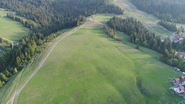 Flight Over the Forest in the Mountains and Village Aerial View of Ukrainian Carpathians