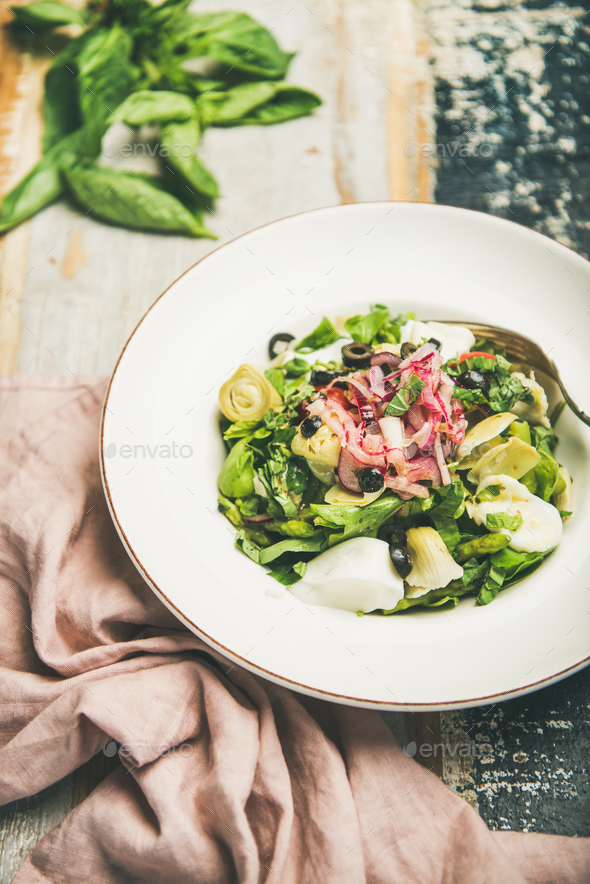 Fresh green summer salad with artichokes and olives - Stock Photo - Images