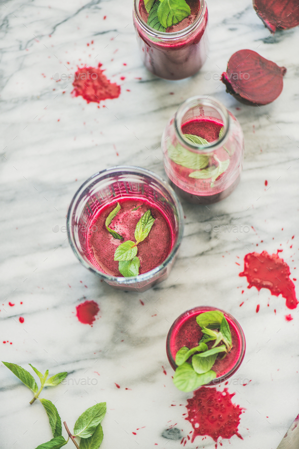 Fresh morning beetroot smoothie in glasses over grey marble background - Stock Photo - Images
