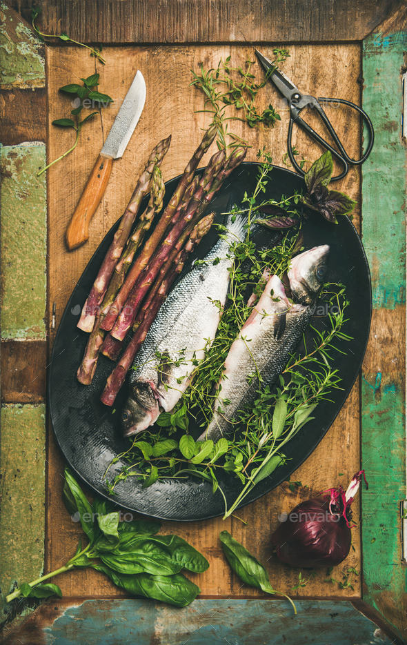 Raw incooked sea bass with herbs - Stock Photo - Images