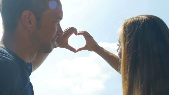 Couple in Love Making Heart Shape with Hands