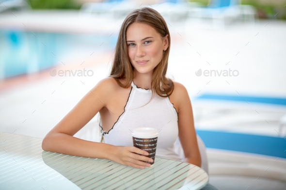 Cute girl having coffee in outdoors cafe - Stock Photo - Images