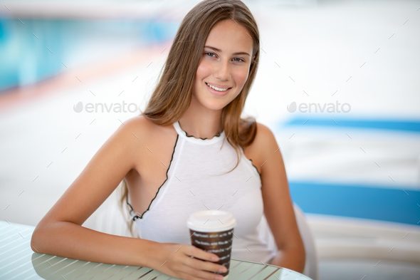 Beautiful woman drinking coffee outdoors - Stock Photo - Images