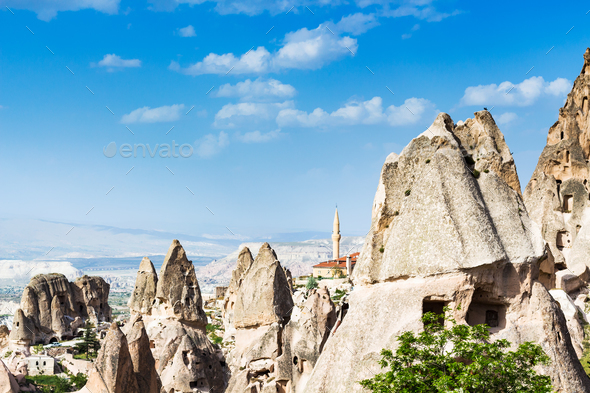 fairy chimney rocks and mosque in Uchisar town - Stock Photo - Images