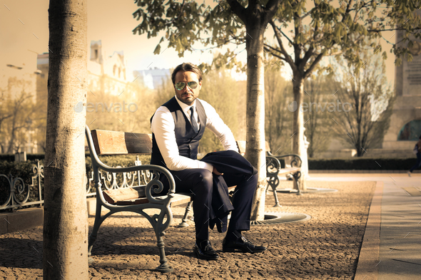 Man sitting on a bench - Stock Photo - Images