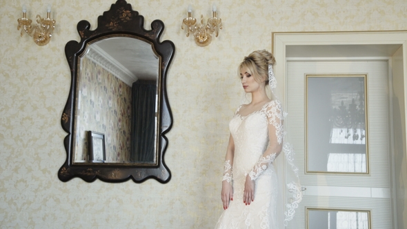 Beautiful Bride Poses and Smiles at Camera in the Luxurious Apartments alt